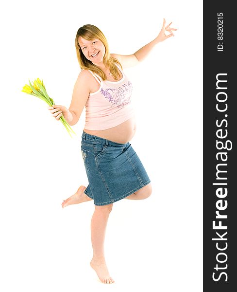 Pregnant woman dancing with yellow tulips on white background