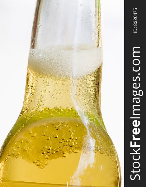 Closeup of bottle of beer with slice of lime in it