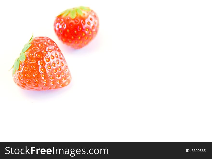 High key image of two strrawberries with a shallow dof on a white background. High key image of two strrawberries with a shallow dof on a white background