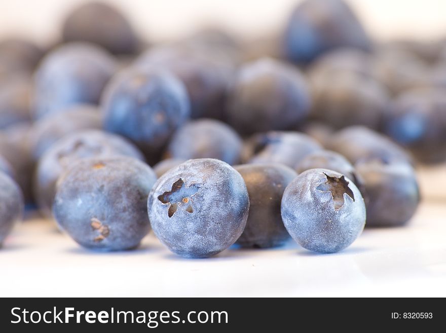 High key closeup of blueberries with a shallow dof on a white background. High key closeup of blueberries with a shallow dof on a white background