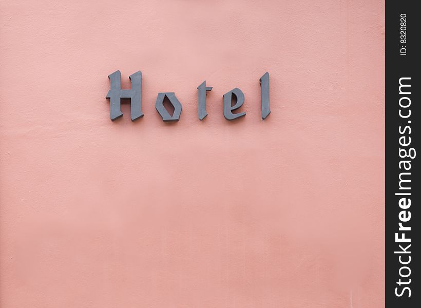Hotel sign and old wall