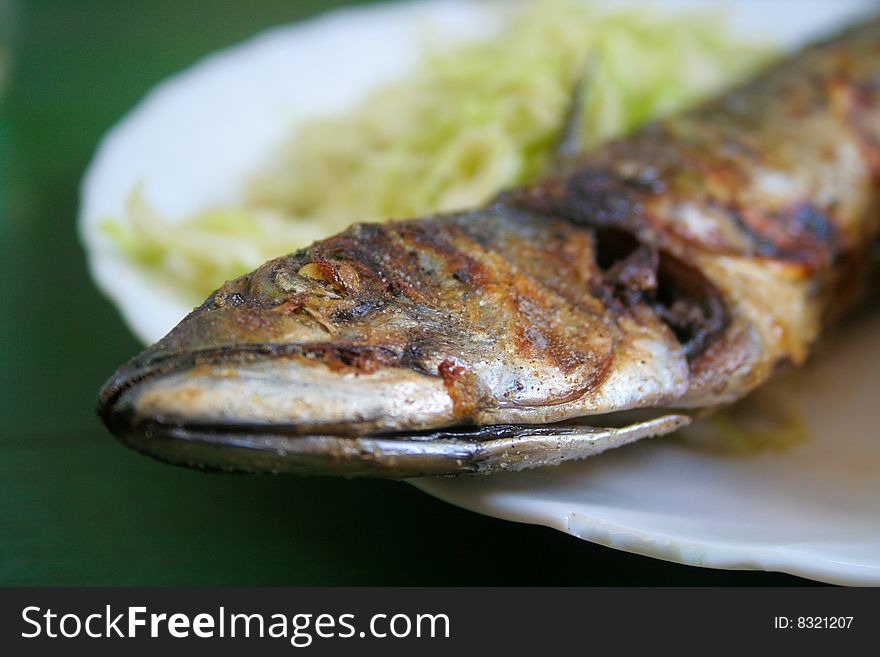 Grilled fish on a plate.