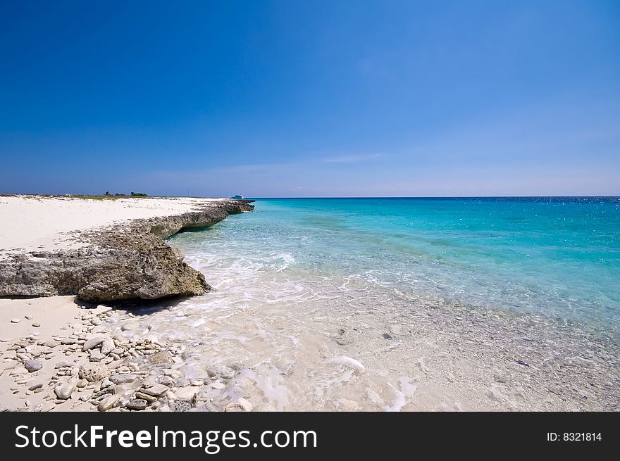 Turquoise sea view with rocky shore