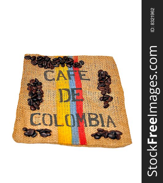 Roasted coffee beans on top of a rugged carpet painted with the Colombian flag colors. Roasted coffee beans on top of a rugged carpet painted with the Colombian flag colors.