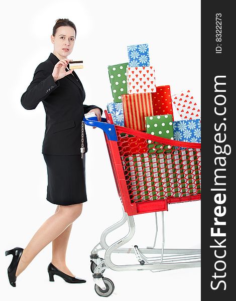 A smartly dressed woman shopping for gifts with a credit card on white. A smartly dressed woman shopping for gifts with a credit card on white