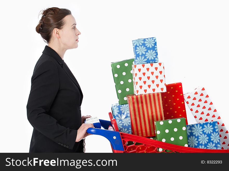 A smartly dressed woman shopping for gifts with a shopping cart. A smartly dressed woman shopping for gifts with a shopping cart