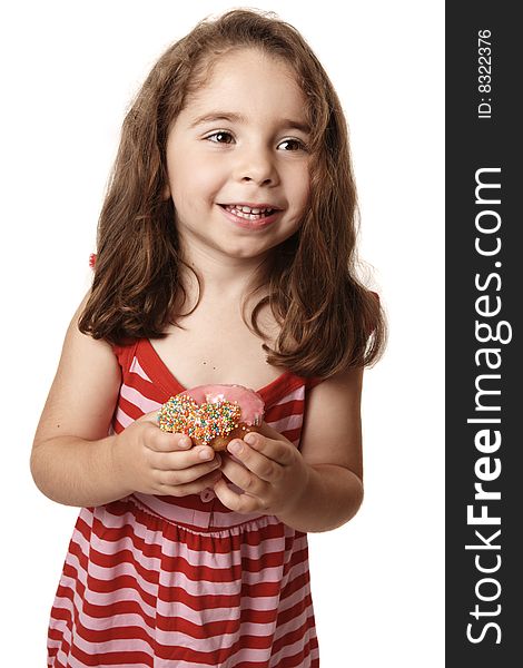 Smiling girl wearing a red striped dress is holding an iced pink doughnut. Smiling girl wearing a red striped dress is holding an iced pink doughnut.