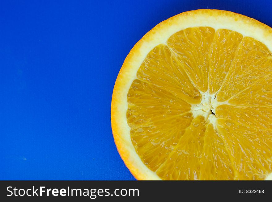 Orange slice on blue background. Orange slice on blue background