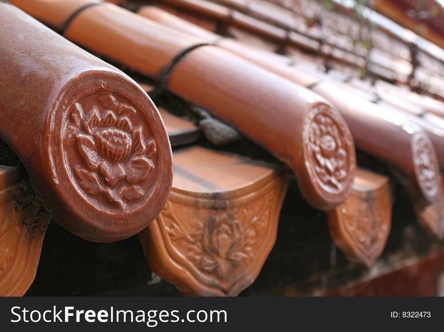 Traditional chinese roof tiles in a temple in Kunming, China.