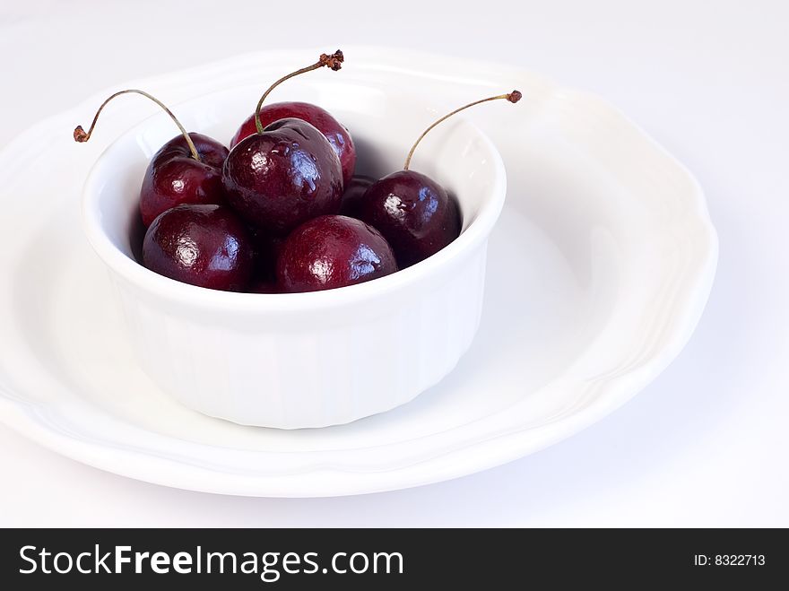 Bowl of fresh juicy cherries  on a plate copy space. Bowl of fresh juicy cherries  on a plate copy space