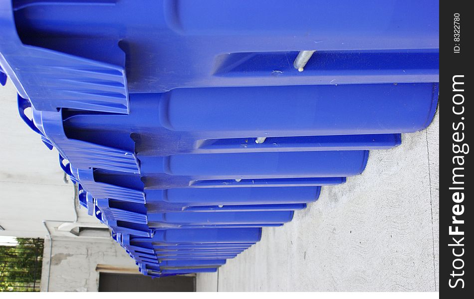 Long row of large blue recycling bins. Long row of large blue recycling bins