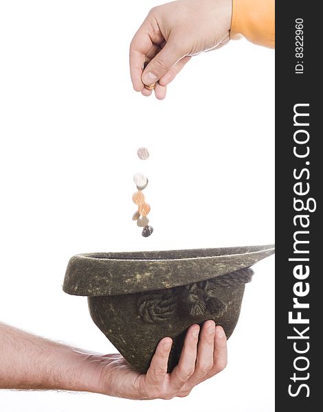 Man hand throw coins to hat in other. Man hand throw coins to hat in other
