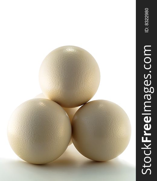 Couple of ostrich eggs lying on each other