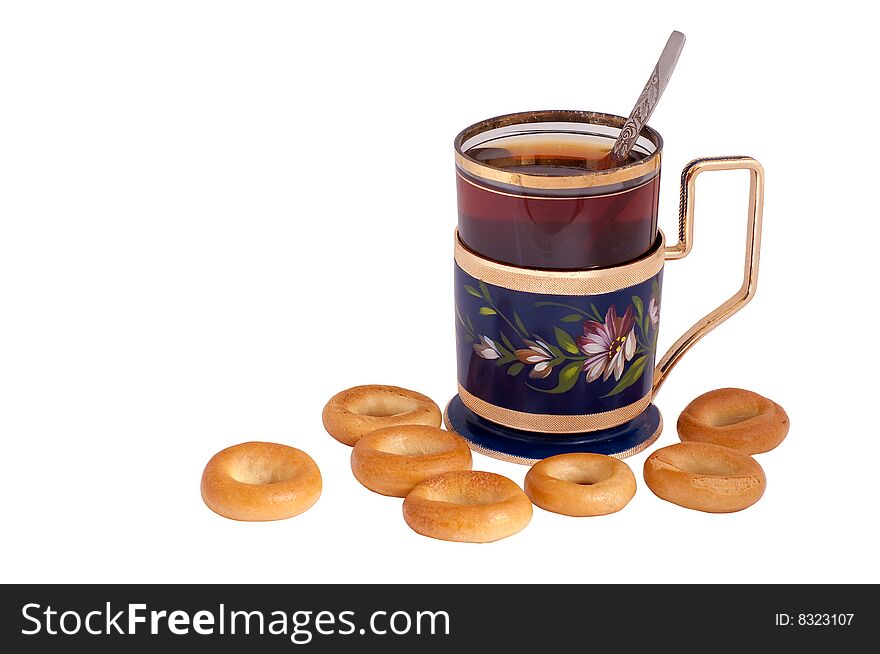 Glass of tea in a glass-holder and bagels. Glass of tea in a glass-holder and bagels