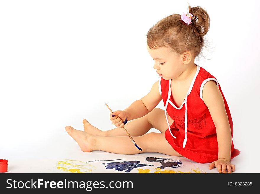 A little girl draws paints. A little girl draws paints.