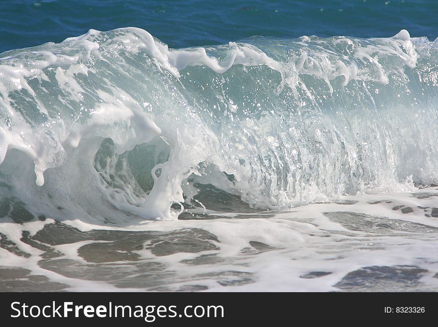 The twirled sea wave approaching on coast