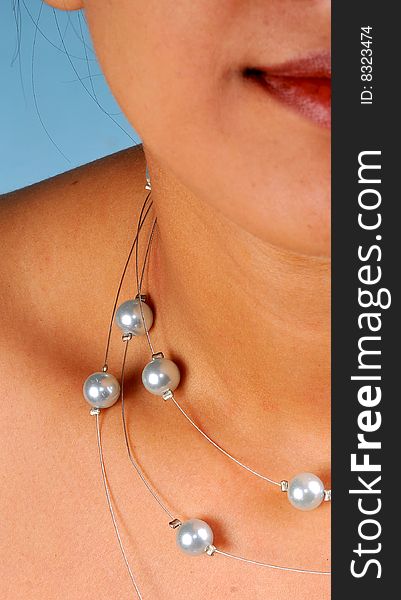 Pearl necklace on model's neck.