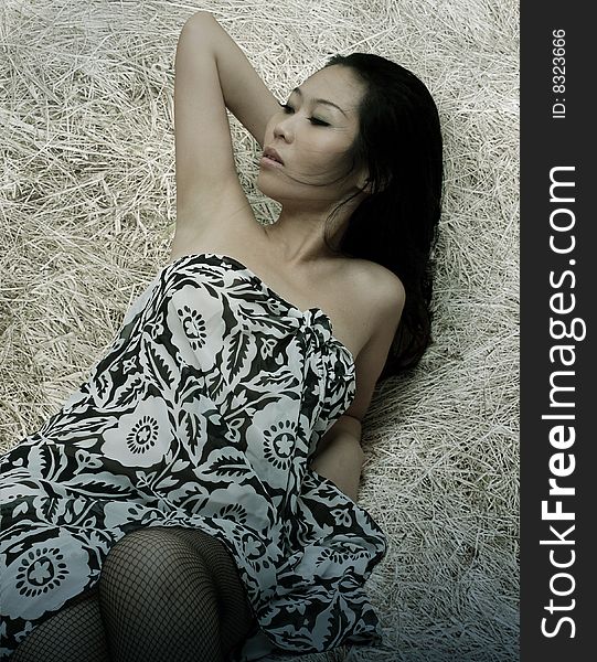 Asian sexy lady lying on a scrap of shredded paper. Asian sexy lady lying on a scrap of shredded paper