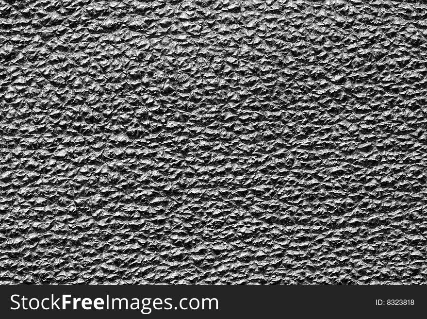 A close-up of the texture of black leather. A close-up of the texture of black leather