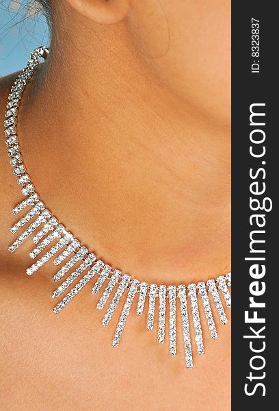 Diamond necklace on model's neck.