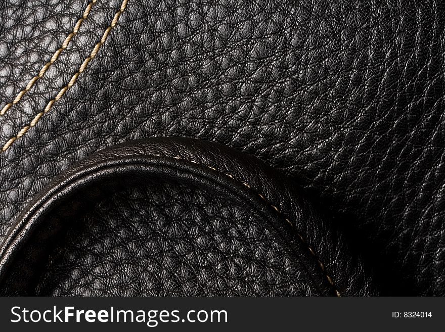 Black leather. Good, clear texture. Shining seam.