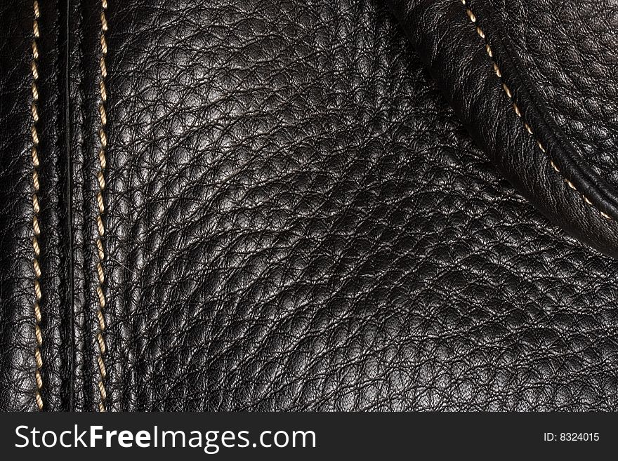 Black leather. Good, clear texture. Shining seam.