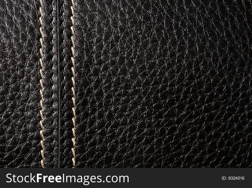 Black leather. Good, clear texture. Shining seam.