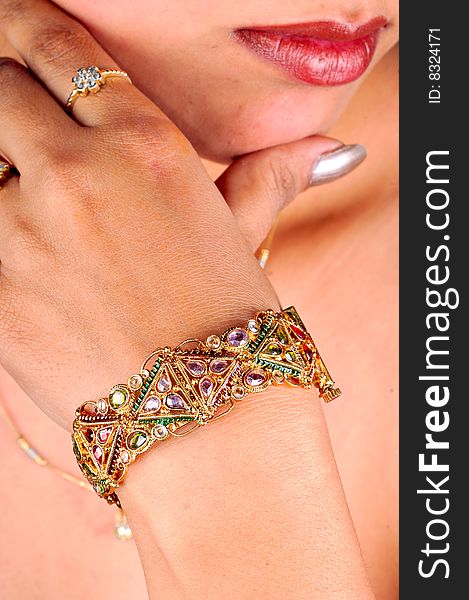 Golden bracelet on model's hand.