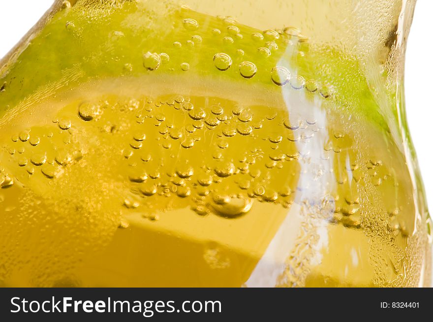 Closeup of bottle of beer with slice of lime in it