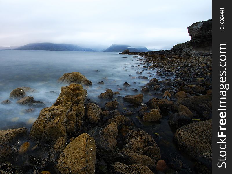 Coastal landscape by a rainy and windy day at Elgol port in scotland, isle of skye.
