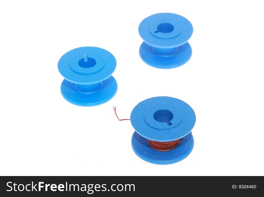 Three blue colored thread spools, isolated on a white background. Three blue colored thread spools, isolated on a white background