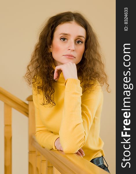 Beautiful young woman standing on a staircase. Beautiful young woman standing on a staircase