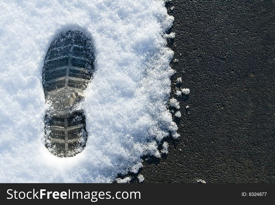 Asphal and snowю
Fresh snow melting on the asphalt