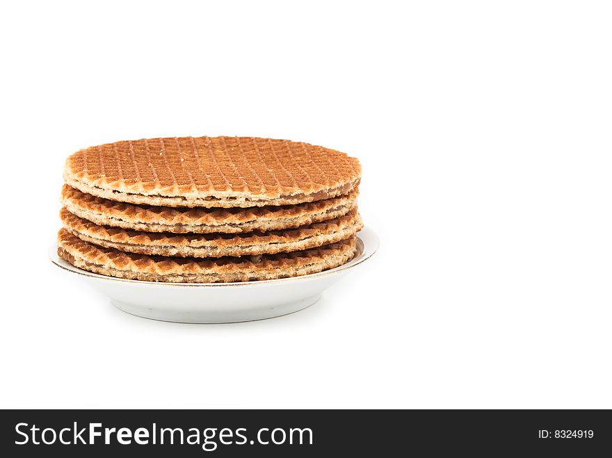 Waffles in a stack on the plate isolated over white background