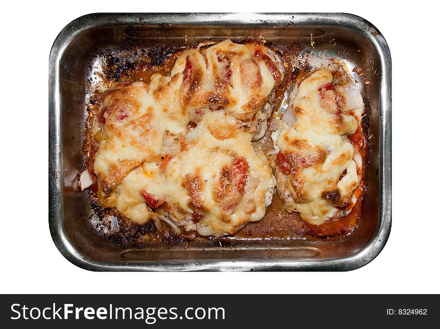 Chicken fillet baked under cheese, mayonnaise and vegetables in the tray