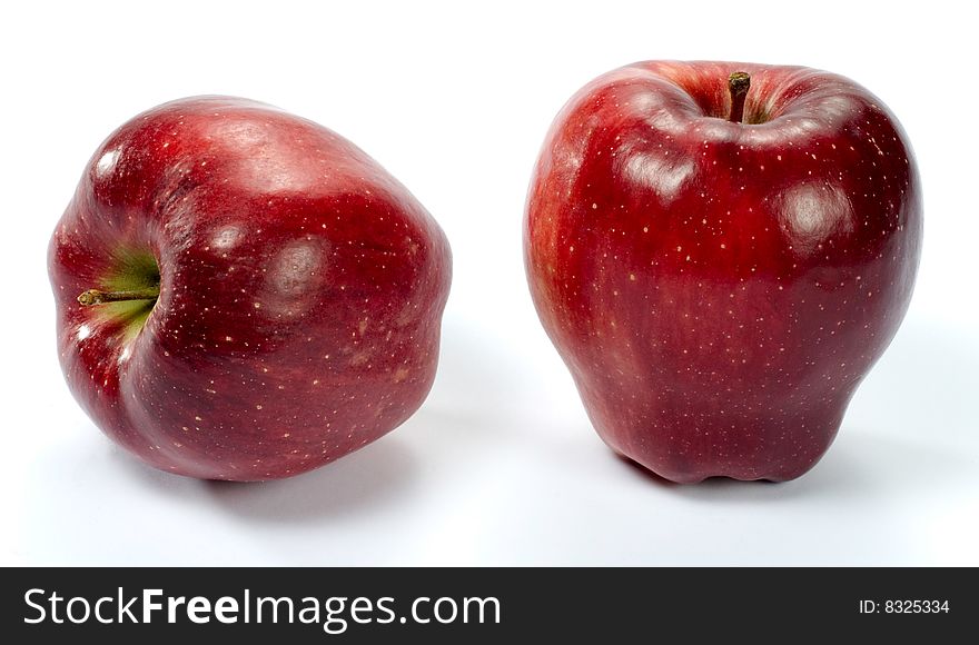 Two red apples in a front view.