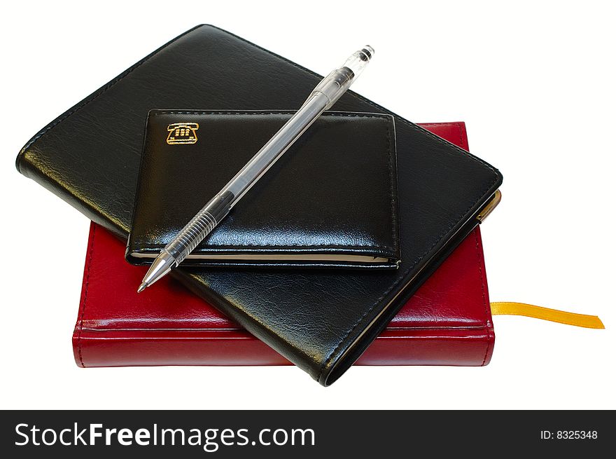 Three notebooks (organizers) and jell pen on isolated background. Three notebooks (organizers) and jell pen on isolated background.