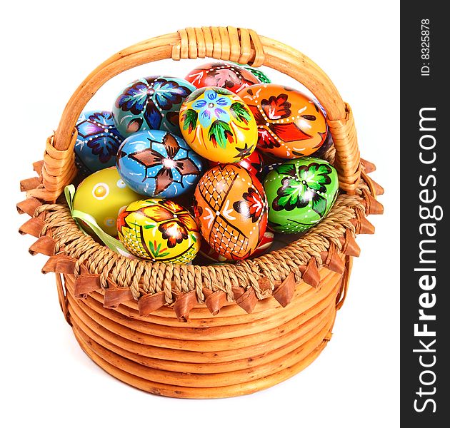 Couple of colorful Easter Eggs in wicker basket.