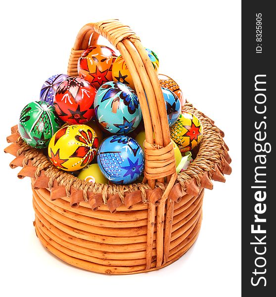 Couple of colorful Easter Eggs in wicker basket.