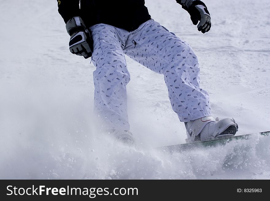 Snowboarder on a ski slope braking