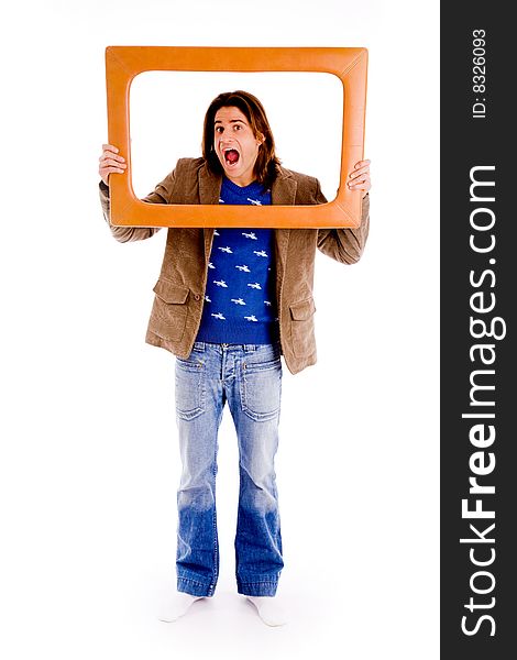 Top view of young man looking through lens against white background