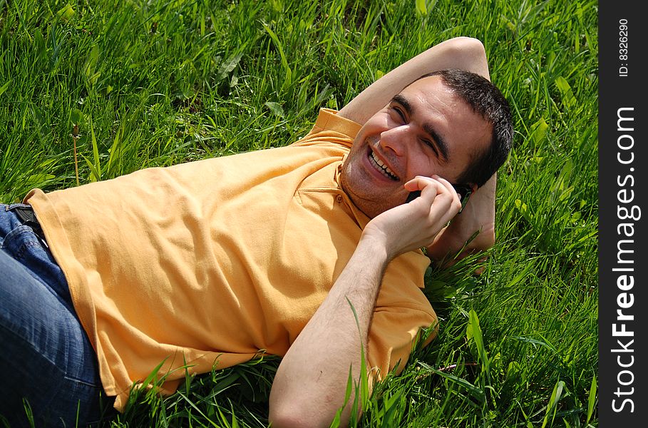 Young man smiles speaking on the phone