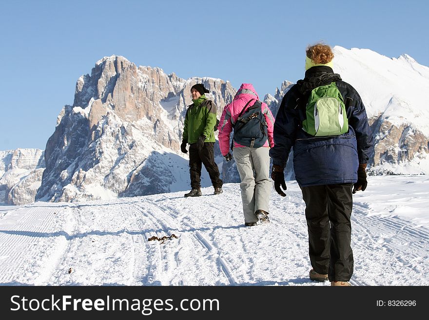 A man and two girls trekking in the snow. A man and two girls trekking in the snow