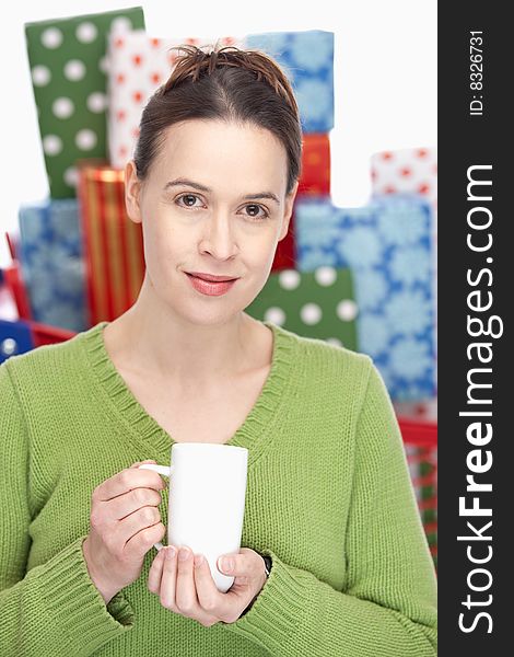 A woman holding a white coffee mug taking a break - shallow depth of field. A woman holding a white coffee mug taking a break - shallow depth of field.