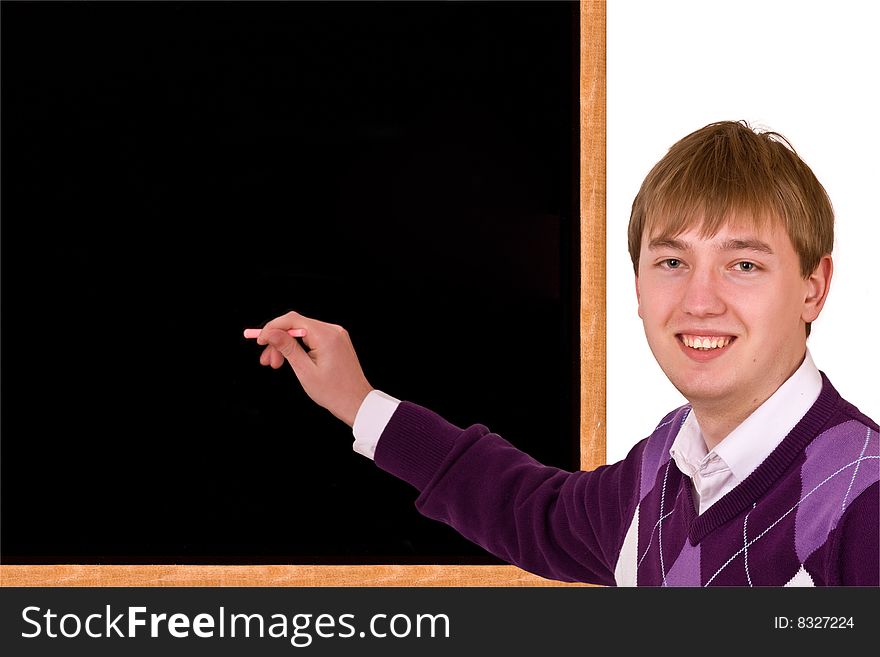 Young Man standing by blank blackboard with stick of chalk in her hand on white background. Young Man standing by blank blackboard with stick of chalk in her hand on white background