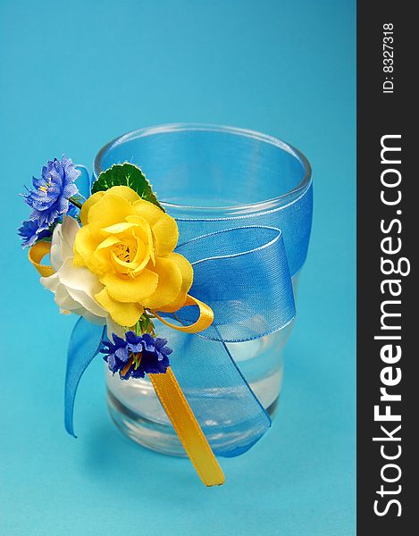 Glasses with flowers isolated on blue