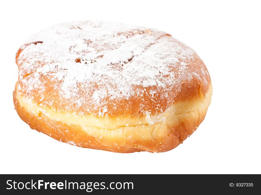 A single fresh powder sugar covered Polish doughnut called Paczek. A single fresh powder sugar covered Polish doughnut called Paczek