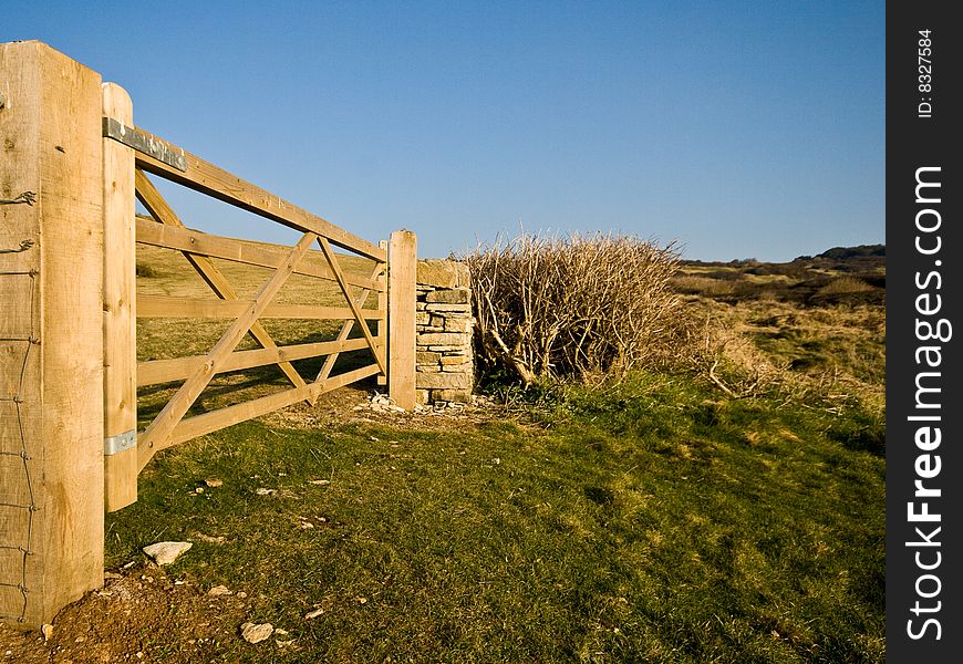 A hand-made gate to a field in the purbecks, lit by morning light. A hand-made gate to a field in the purbecks, lit by morning light