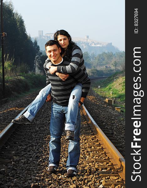 Young couple walking on railway tracks