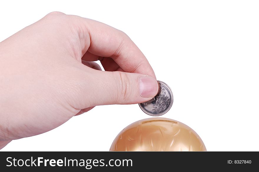 Male hand dropping a coin into a  bank. Male hand dropping a coin into a  bank